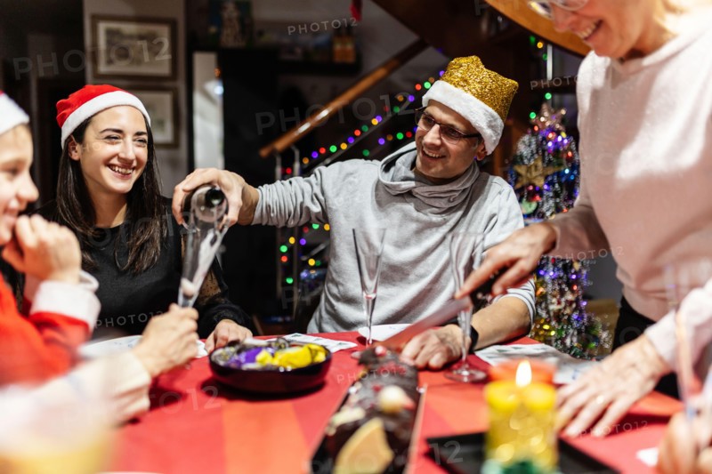 Cheerful multi generational family in Santa Claus celebrating christmas