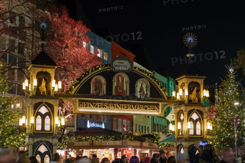 Night atmosphere in front of beautiful arched entrance of Weihnachtsmarkt, Christmas Market in Köln, at Alter Markt, famous marketplace nearby Cologne
