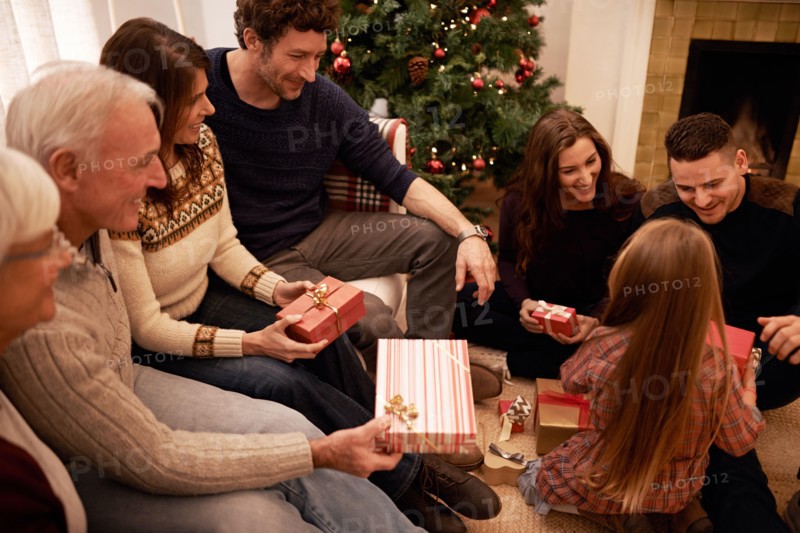 Enjoying a cosy family Christmas. a a family giving presents at christmas.