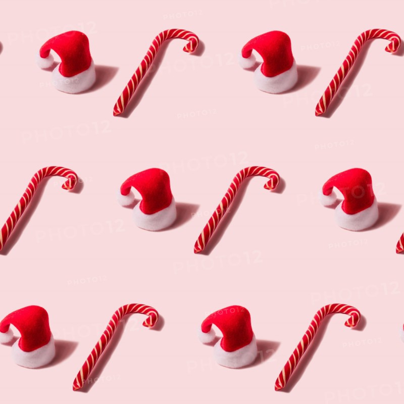 Trendy Christmas seamless texture with Santa Claus hat and candy cane. Modern christmas design