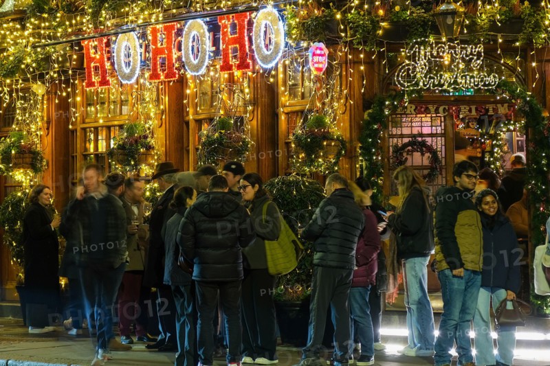 London, UK. 14th November, 2024. The Churchill Arms in Kensington switches on its festive light display with the external walls covered in over 80 Christmas trees and decorations. The pub attracts many visitors with its impressive seasonal floral and plant displays all year round.  Credit: Eleventh Hour Photography/Alamy Live News