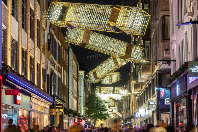 LONDON, UK - 9TH NOV 2024: A view along Carnaby Street at Christmas showing the decorations and lights. People can be seen below the decorations along
