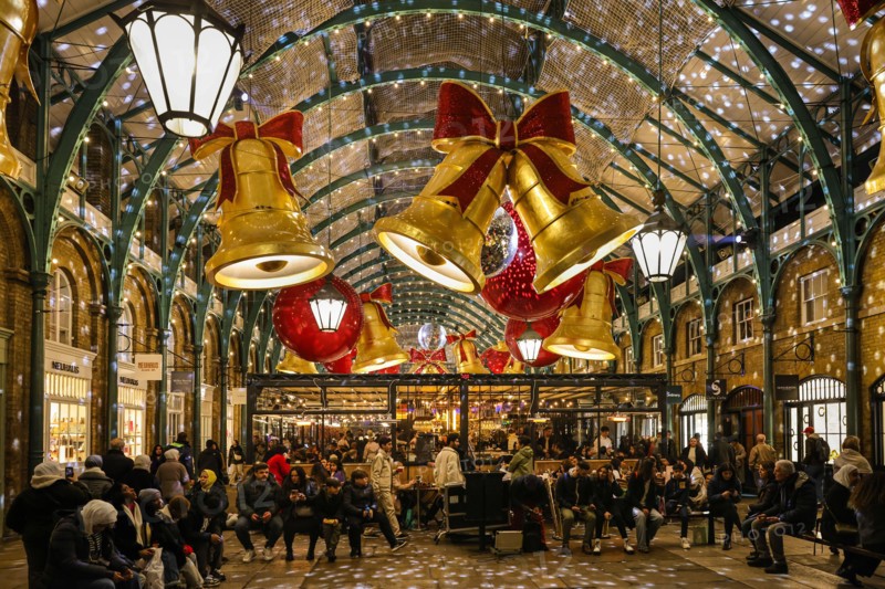 London, UK. 01st Dec, 2024. The former market halls of Covent Garden are decorated with giant bows and baubles as shoppers search for Christmas Presents in shops and along the small stalls of the covered Apple Market. Credit: Imageplotter/Alamy Live News