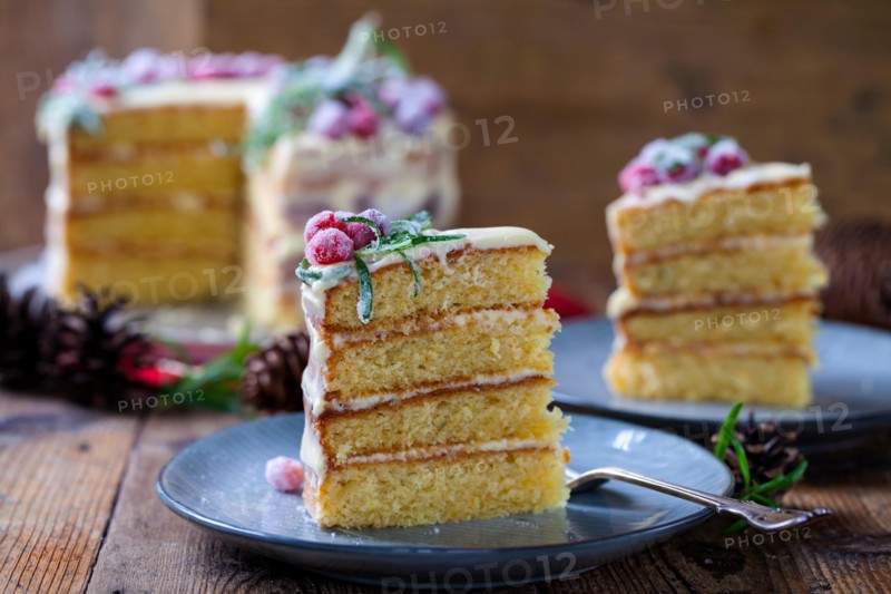 layered Christmas cake with sugared cranberries and rosemary