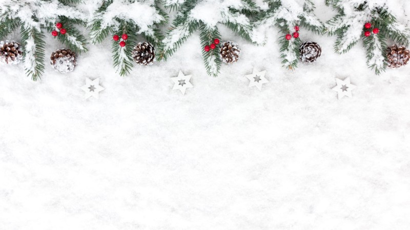 Christmas Background with snow, white wooden christmas stars, snowy pine cones, red berries and natural fir tree twigs. Top View.