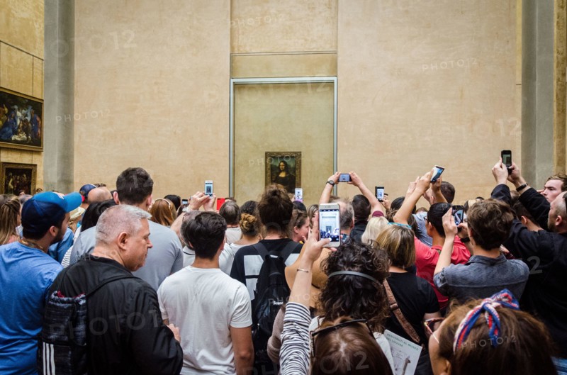 Crowd of people taking pictures of Mona Lisa by Leonardo da Vinci at The Louvre, Paris, France