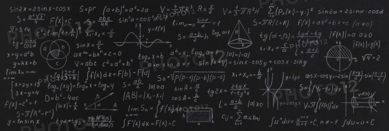 Formulas and calculations from mathematics and geometry on school blackboard