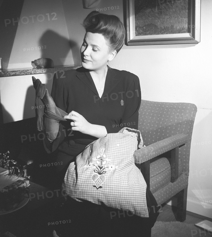 Nylon stockings in the 1940s. A young woman is holding a nylon stocking in her hand. The nylon stocking was very popular in the 1940s, a trendy accessory that was very expensive to buy during time of world war II. She is actress Birgit Tengroth, 1915-1983.  Sweden 1944. Photo Kristoffersson ref G85-4
