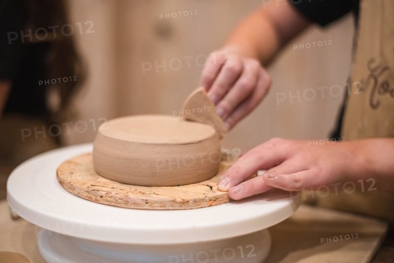 Woman hands, pottery studio and painting cup in workshop for sculpture, creative manufacturing or design. Painter, ceramics product and brush process,