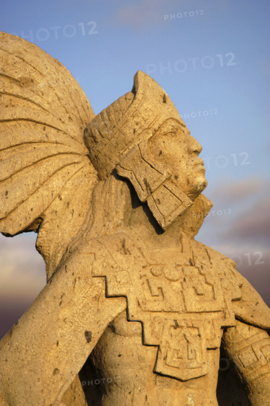 A statue of Cuauhtemoc glows in the sunset in Ensenada Baja California Mexico