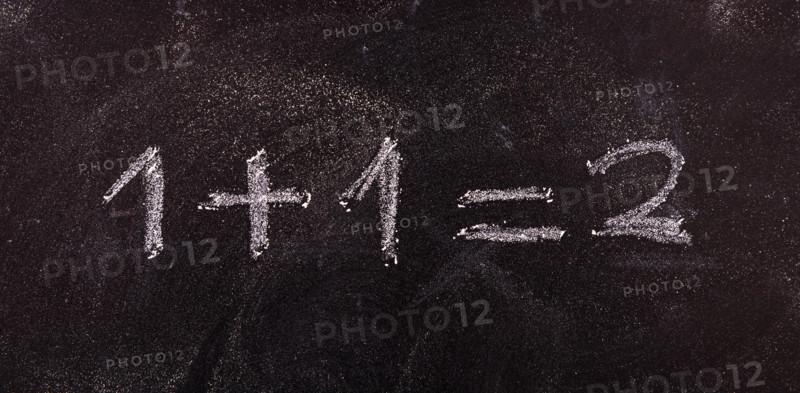 School maths concept. Math simple equation 1+1=2, isolated, on blackboard background.
