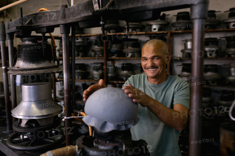 Portrait of man working in a hat factory