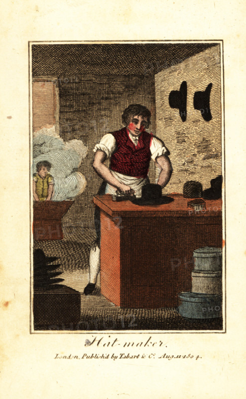 Hat maker ironing the brim of a hat made from beaver fur. In the background, an apprentice works the felt in a battery (hot-water kettle). Handcoloured woodcut engraving from The Book of English Trades and Library of the Useful Arts, Tabart, London, 1810.