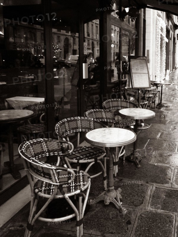 Paris, France, Parisian cafe, tables and chairs on paved sidewalk, black and white photo.