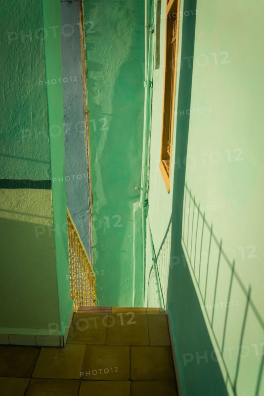 Detail of a pastel green staircase with shadows, Havana, Cuba