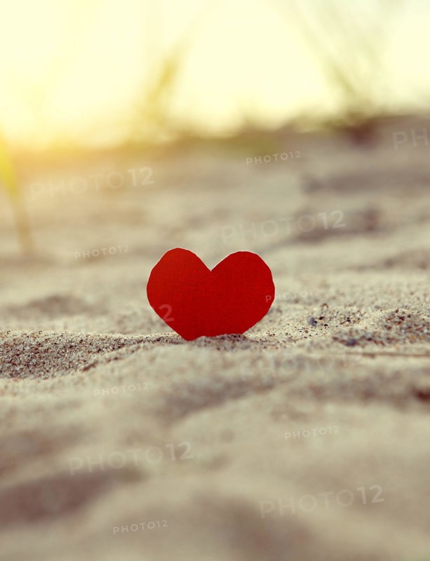 Toned Photo of the Red Heart in the Sand at the Evening Beach