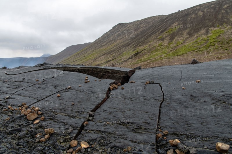Close up view of cracked lava crust or ingenious rock, cooled down from 2021 eruption of volcano Mt. Fagradalsfjall in Geldingadalir valley on Reykjan