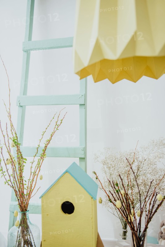 easter decoration. easter eggs with wooden feeder and mimosa.