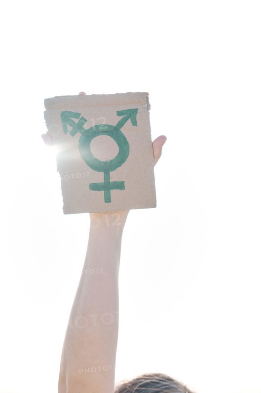 transgender symbol in hands on a cardboard