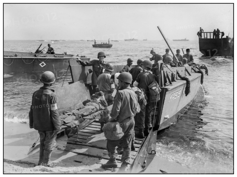 1944 WW2 St. Tropez wounded US soldiers are loaded onto a LCVP for transfer to hospital ship Invasion troops of U.S. Army establishes a beachhead in Saint-Tropez, France during World War II.  Wounded U.S. soldiers are placed aboard LCVPs (Landing Craft, Vehicle, Personnel)            South of France 1944 World War II Second World War