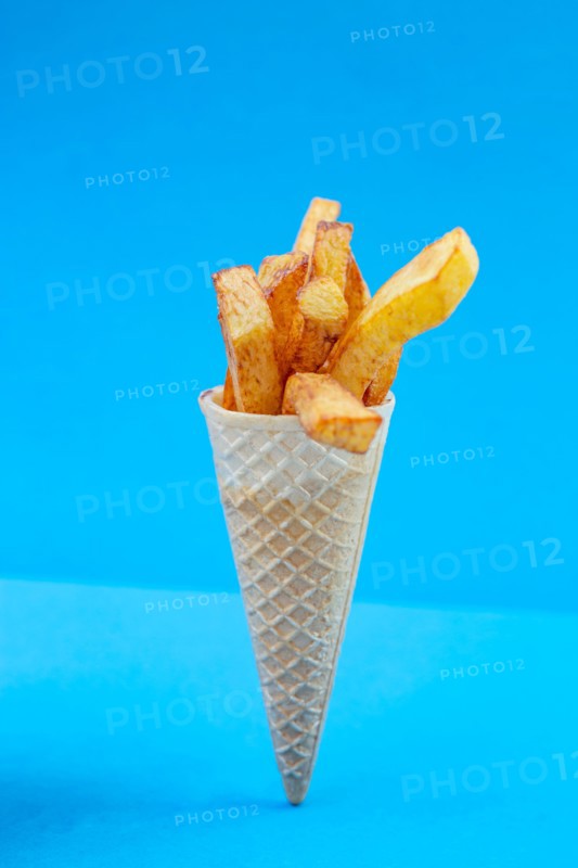 French fries bouquet in a ice cream cone on blue background. Fast food, street food concept.