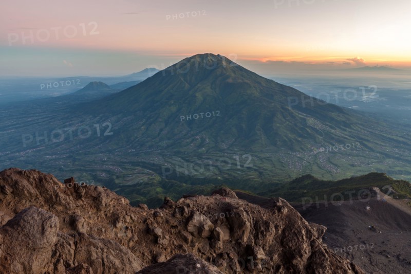 View of green Merbabu volcano from Merapi mountain. Java island, Indonesia.