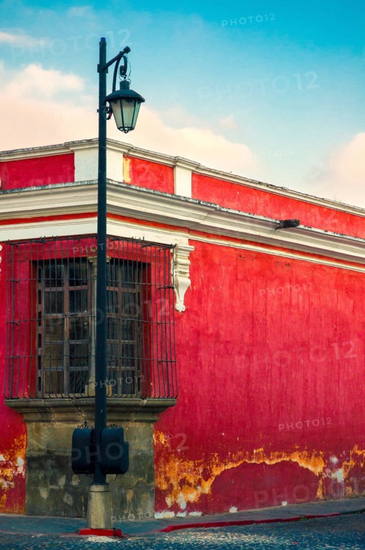 Balcony in corner house and lantern in the colonial city of La Antigua Guatemala, ancient architectural space, conservation and heritage of humanity.