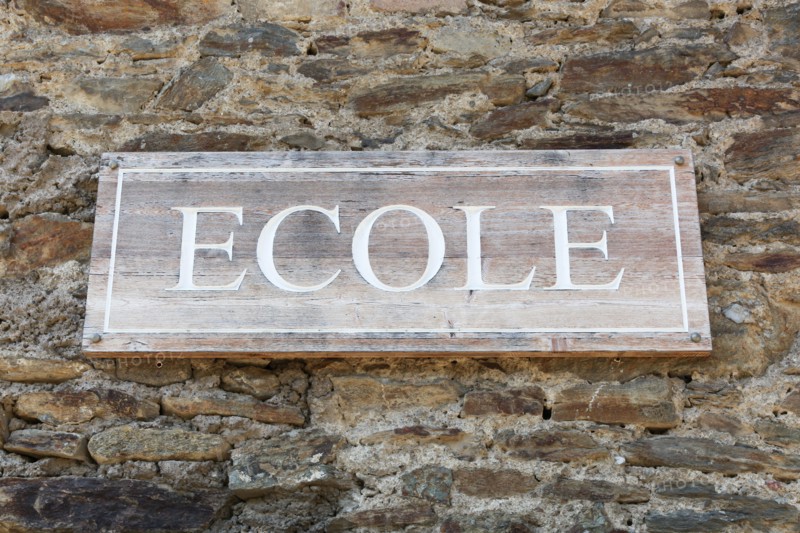 School signboard on a wall called ecole in French language