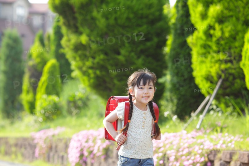 Girl walking with school bag on her back
