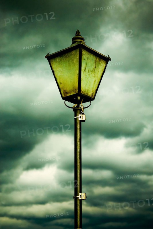 Vintage Street Lamp Against a Dramatic Overcast Sky on a Cloudy Day