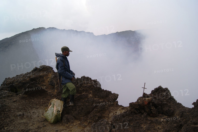 Virungas National Park, DRC: A park ranger stands at the mouth of Nyiragongo, one of the most active volcano's on earth.