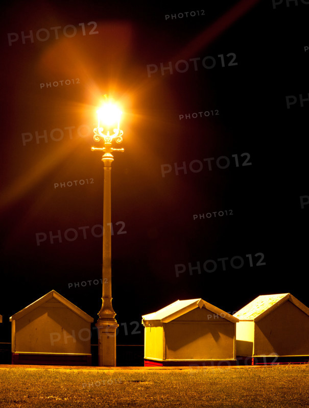 Beach Huts at Night Under a Street Light