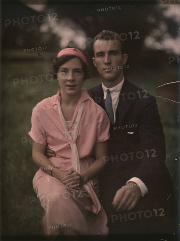 This vintage photograph depicts a couple from a past era, providing a glimpse into the historical fashion and relationship dynamics of an earlier time period.