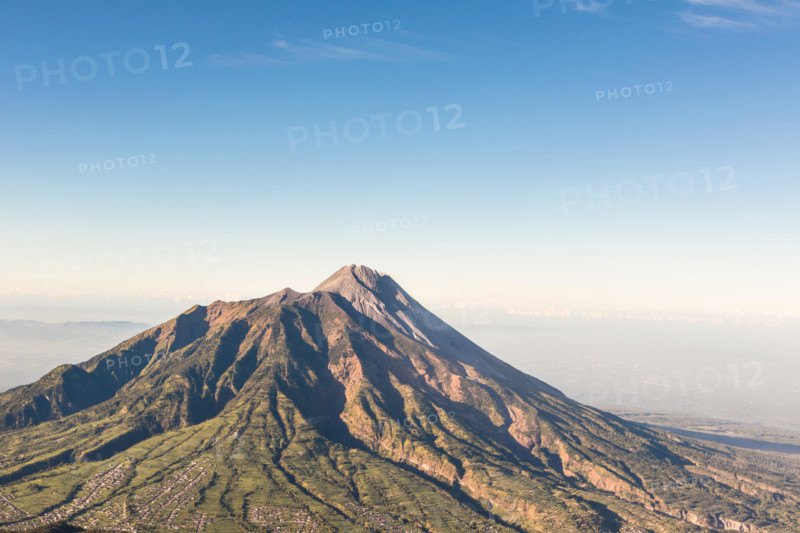 A view of Merapi volcano from the Merbabu volcano near the touristic city of Yogyakarta  in central  Java in Indonesia