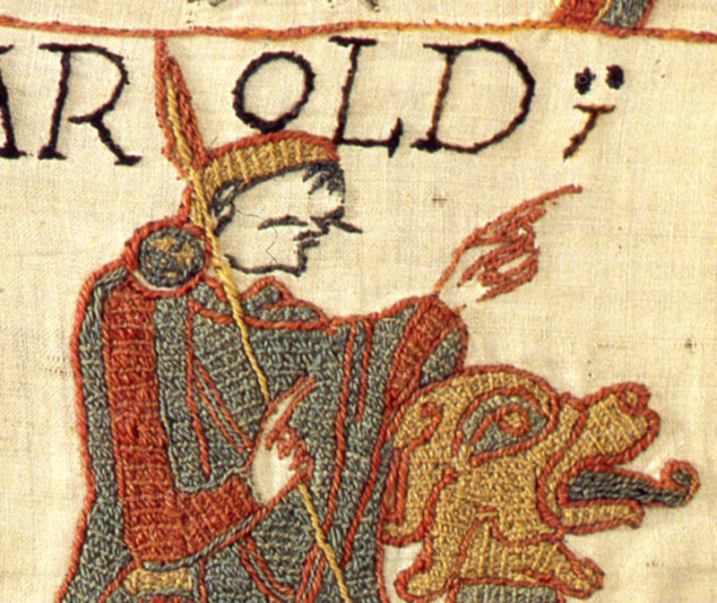 This detailed view of the Bayeux Tapestry reveals the intricate stitching techniques used to create this historical embroidery. The tapestry illustrates scenes from the Norman Conquest of England, capturing the drama and events of the 11th century.
