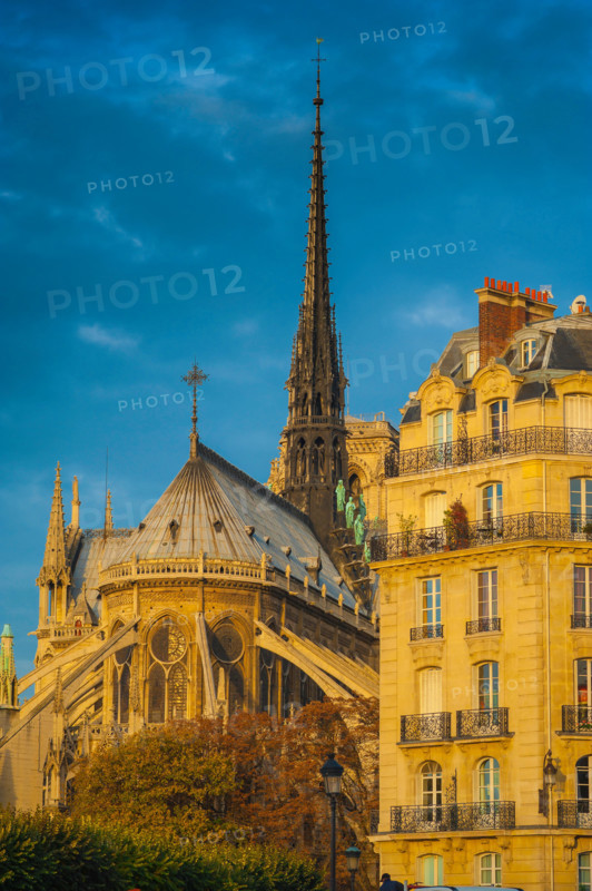 Paris architecture, the east end of Notre Dame Cathedral alongside a typical 19th century apartment building on the Ile de la Cite in Paris, France.