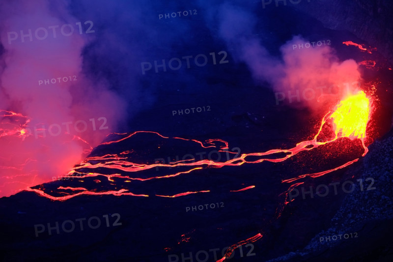 Lava and steam in crater of Nyiragongo volcano in Virunga National Park in Democratic Republic of Congo, Africa. Picture taken during dusk with blue c