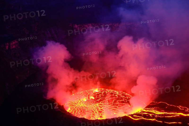 Lava and steam in crater of Nyiragongo volcano in Virunga National Park in Democratic Republic of Congo, Africa. Picture taken during dusk with blue c