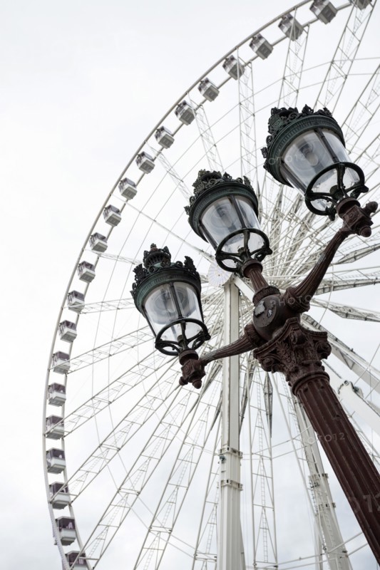 The Big Wheel at Place de la Concorde and a street lamp in the foreground in Paris. France