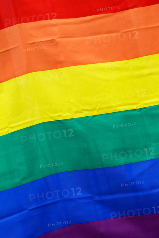 Close-up of a flag with rainbow pattern.
