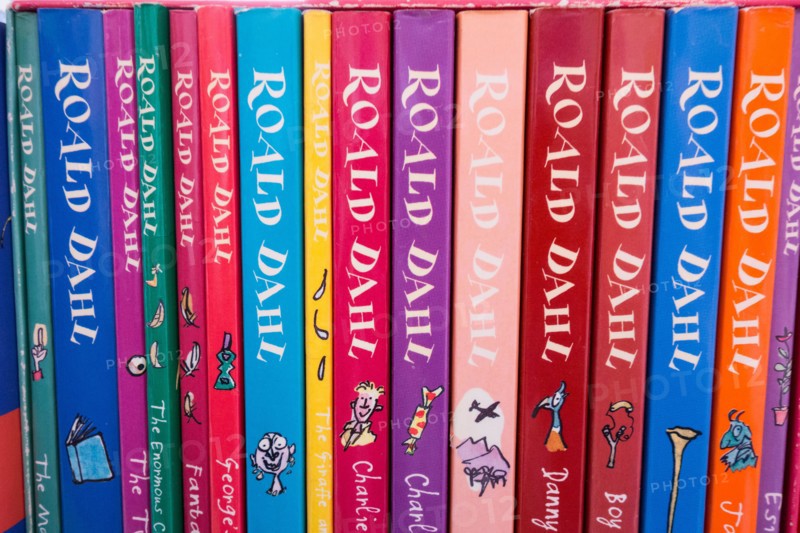 Closeup of colourful Roald Dahl book covers, spines, illustrations and artwork
