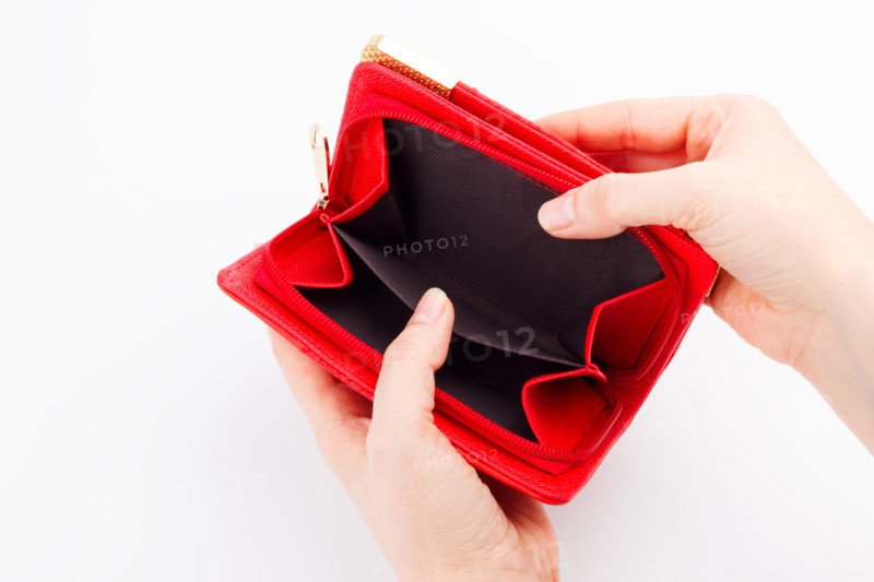Female hands with an empty wallet on white background