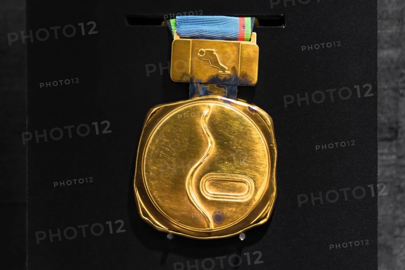 tokyo, japan - march 2 2021: Close up on the official gold medal used during the 1972 Winter Olympics of Sapporo exhibited in the Japan Olympic Museum