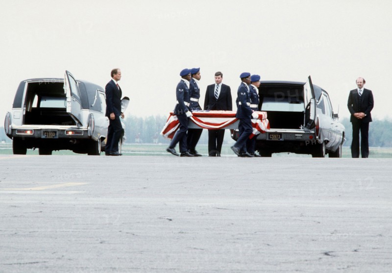 Air Force pallbearers carry a coffin containing the remains of a crew member from the space shuttle Challenger to the back of a hearse. The Challenger exploded shortly after takeoff on January 28, 1986, killing all seven members of its crew. Base: Dover Air Force Base State: Delaware (DE) Country: United States Of America (USA)