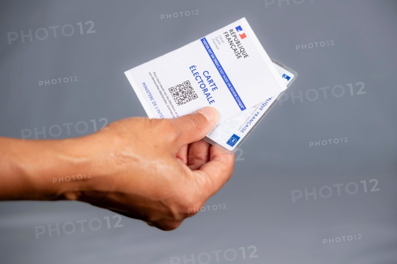 Woman holding a French electoral and identity card, elections in France