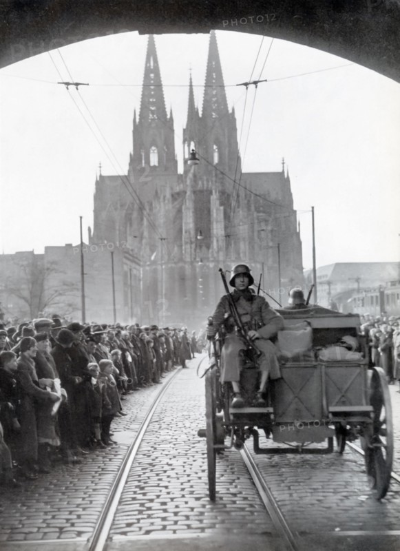 A photograph shows German troops crossing the Rhine into the Rhineland on March 7, 1936. This event marked a critical moment in Nazi Germany's aggressive expansion, as it violated the Treaty of Versailles and the Locarno Treaties. The remilitarization of the Rhineland was a bold move by Adolf Hitler, testing the resolve of France and Britain and significantly altering the balance of power in Europe, setting the stage for further territorial ambitions.