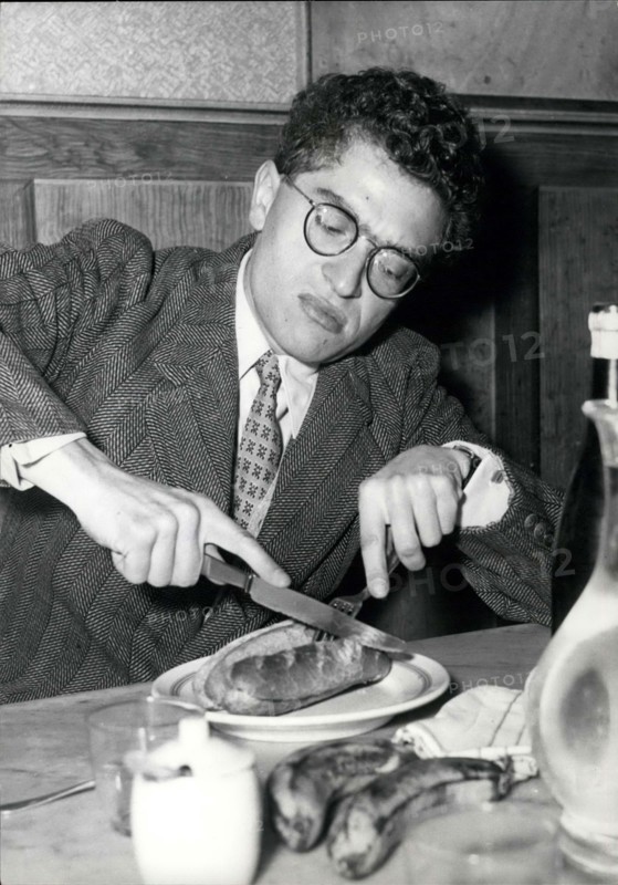 Apr. 28, 1958 - Darry Cowl As School Teacher Darry Cowl, the famous French screen Comedian, is starring in the new film ''Le Petit Prof'' (Little School Teacher) now in the making. Some of the scenes were filmed at Janson-de-Sailly, the well-known Paris High School for boys. OPS:- Darry Cowl seen having a quick lunch between two scenes.