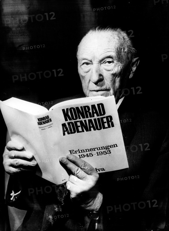 Konrad Adenauer holding an edition of his memoirs
