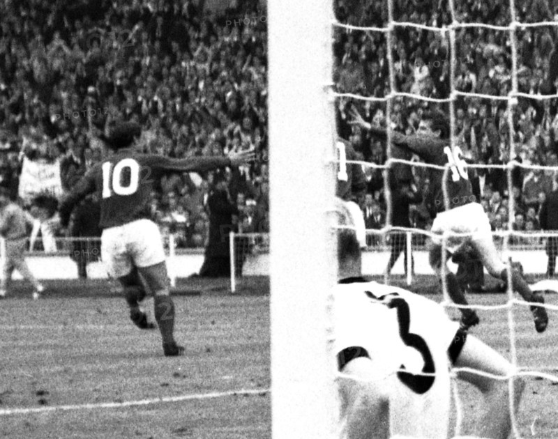 England versus West Germany 1966 World Cup Final, Wembley Stadium England's Martin Peters turns to celebrate his 18th minute goal with Geoff Hurst and Roger Hunt as West Germany's Hans Tilkowski picks the ball out of the net and Number 3, Karl-Heiz Schnellinger is left on the deck  Photo by Tony Henshaw Archive