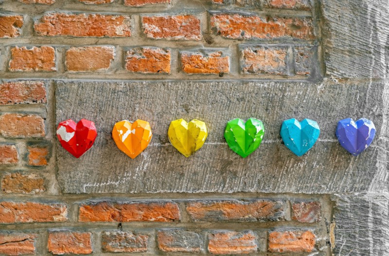 Rainbow flag decoration on brick wall, pride month concept